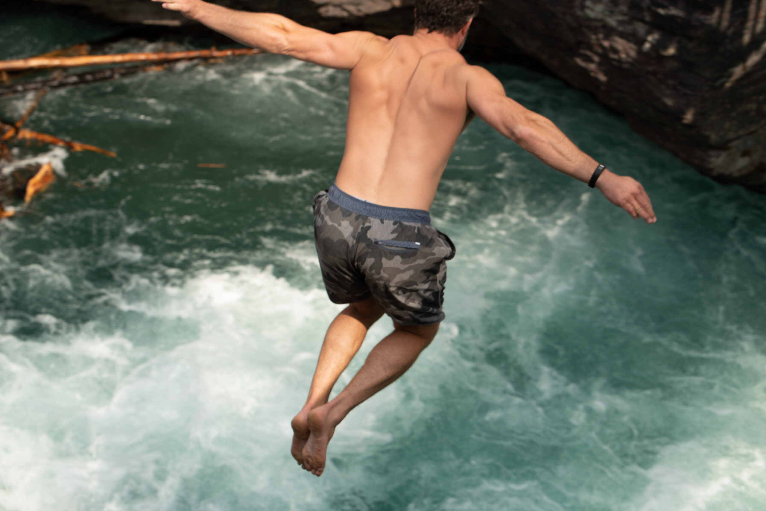 a man jumping into a river